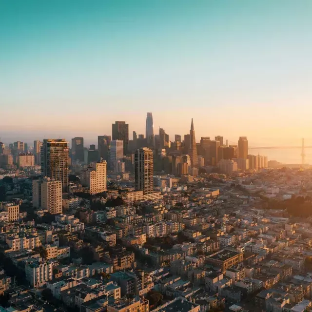 的 skyline of 贝博体彩app is seen from the air in a golden light.