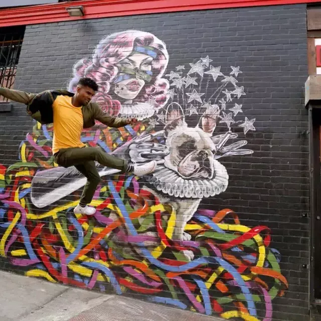 Artist Serge Gay Jr. in front of one of his many murals.